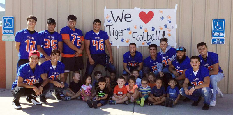 LLHS football players read to local children