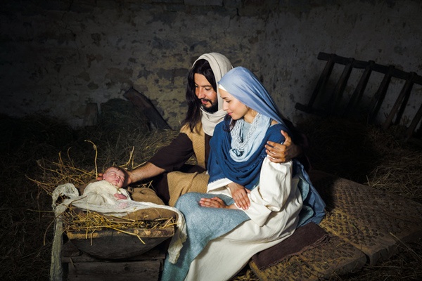 Live Christmas nativity scene in an old barn - Reenactment play with authentic costumes. The baby is a (property released) doll.