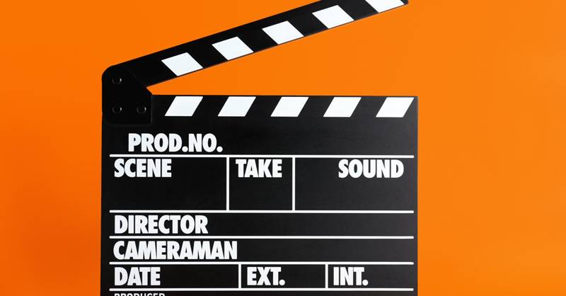 Clapper board on orange background. Cinema production
