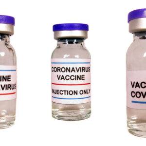 Different versions of corona virus vaccine in bottles, on white studio background.